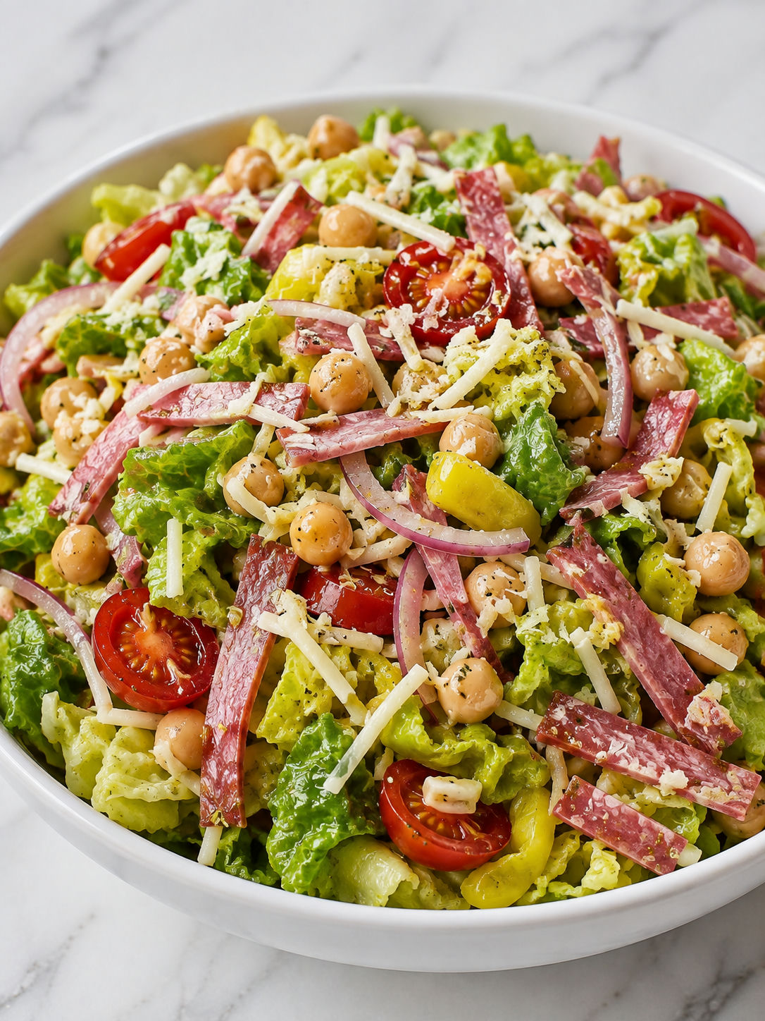 Hearty chickpea chopped salad with salami, mozzarella, and tomatoes