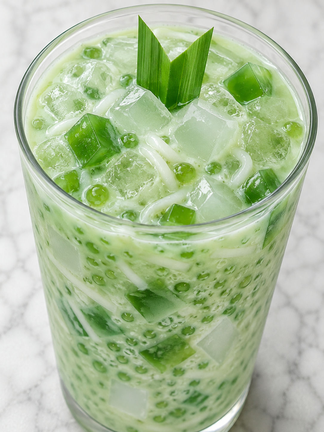 Creamy green sago drink with pandan jelly, coconut, and ice
