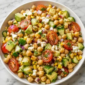 Chickpea avocado salad with corn, tomatoes, cucumber, feta, and parsley