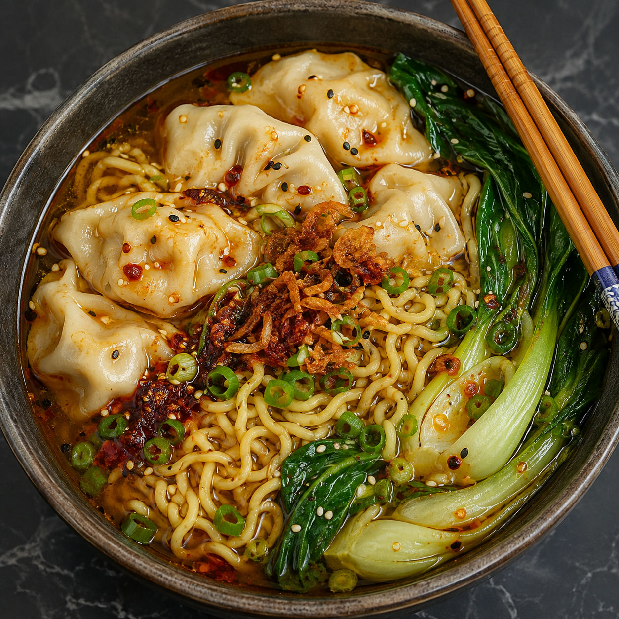 Dumpling noodle soup with ramen, bok choy, chili crisp, and scallions