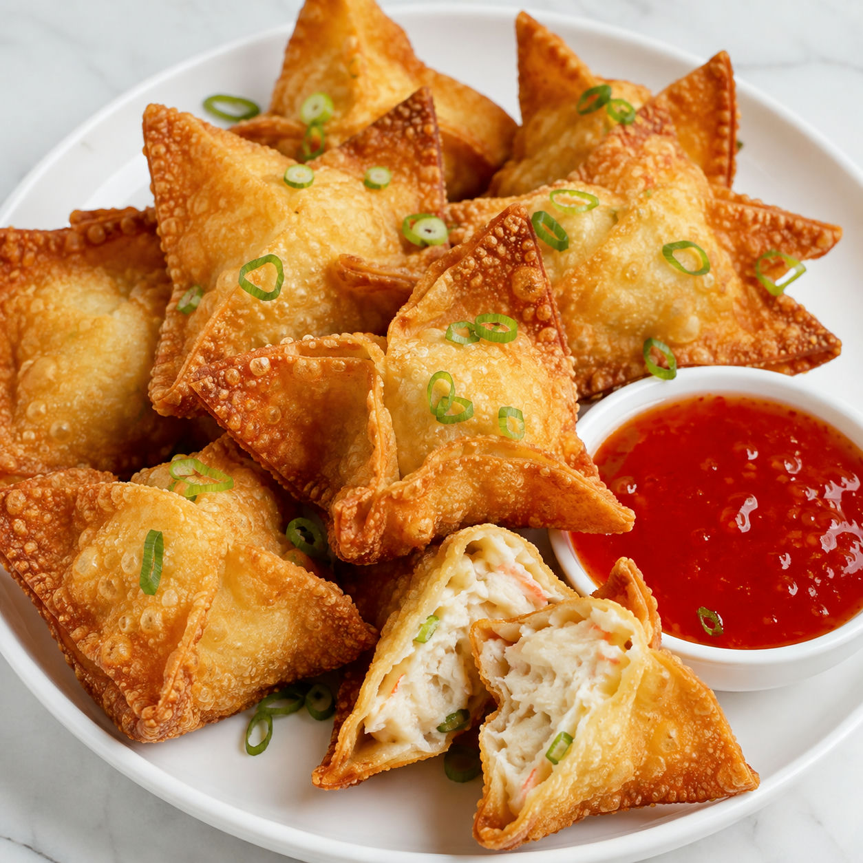 Golden Crab Rangoon with creamy filling and sweet chili sauce