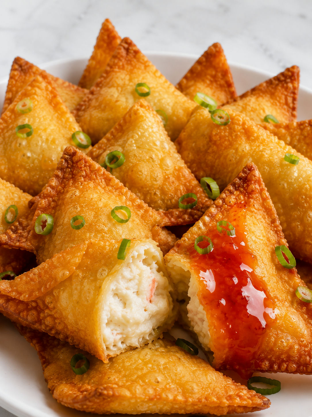 Crispy Crab Rangoon with creamy crab filling and sweet chili sauce