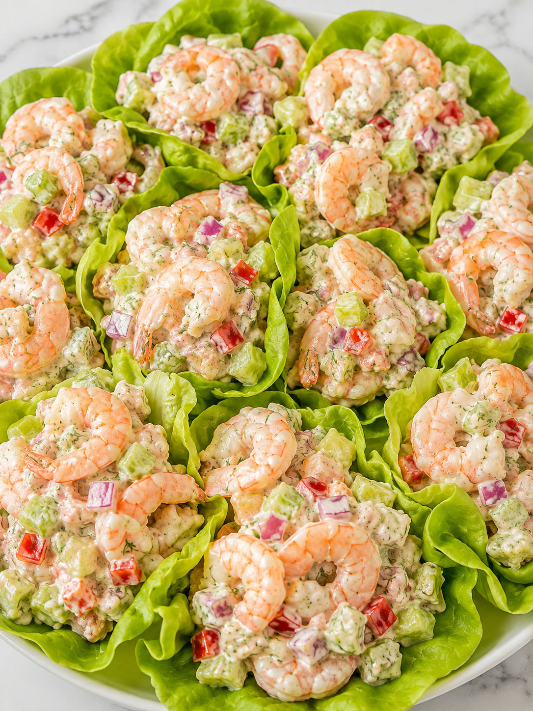 Creamy shrimp salad in lettuce cups with dill and red pepper