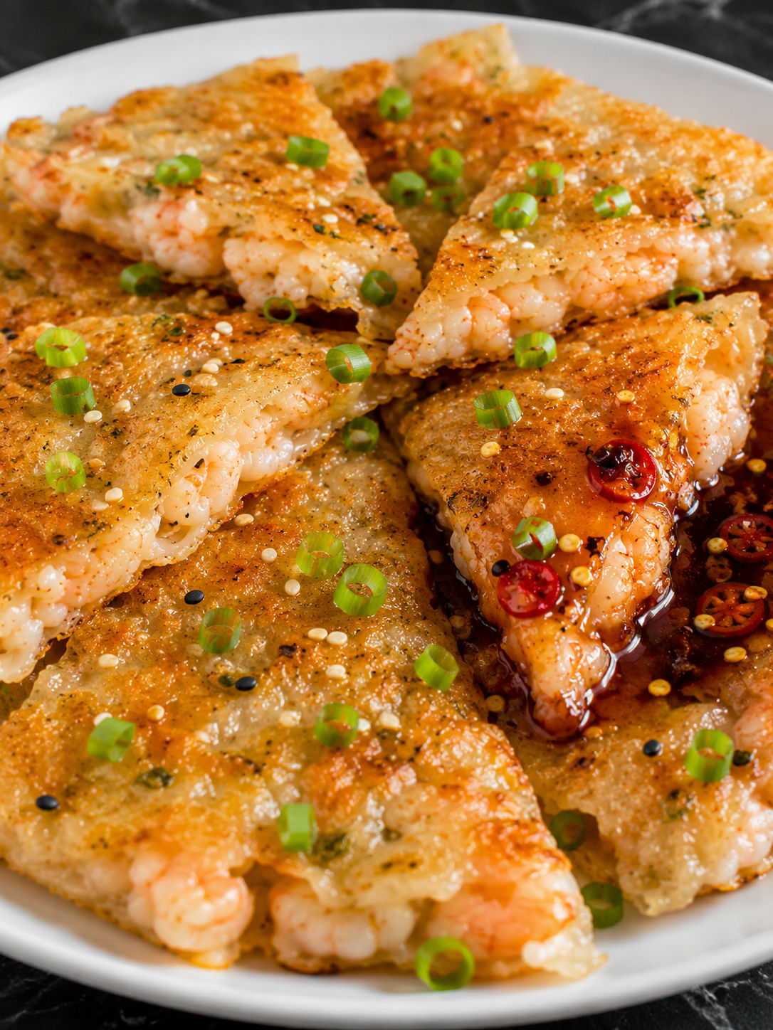 Golden crispy rice paper shrimp pancake wedges with soy chili dipping sauce