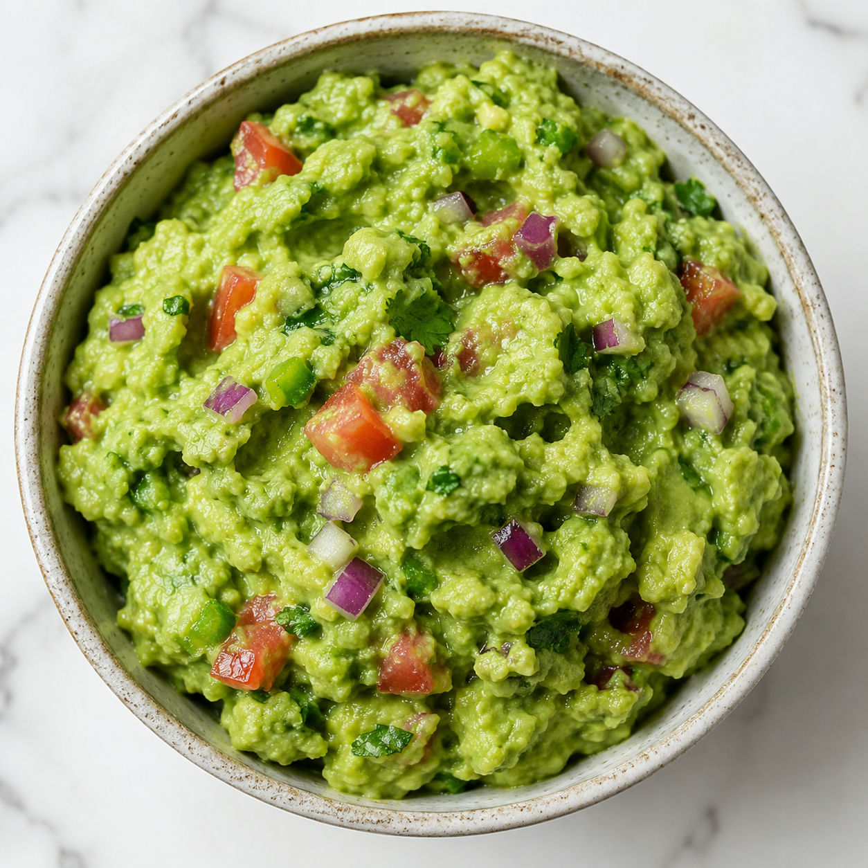 Classic guacamole with tomato, red onion, cilantro, lime, and tortilla chips