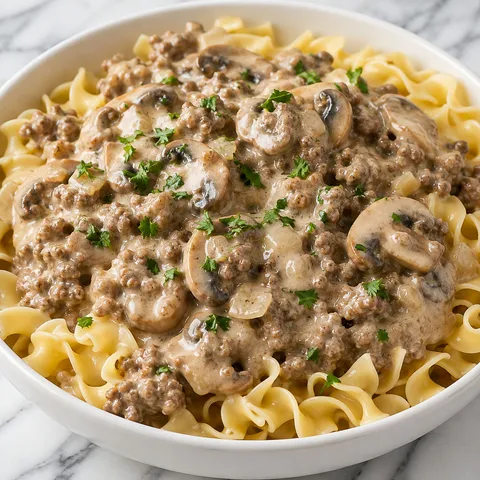 Creamy ground beef stroganoff over egg noodles with mushrooms and parsley