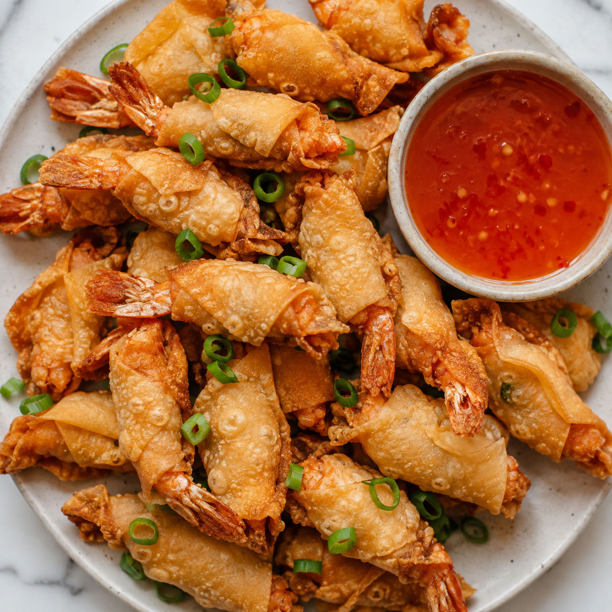 Golden wonton shrimp with sweet chili sauce and green onions