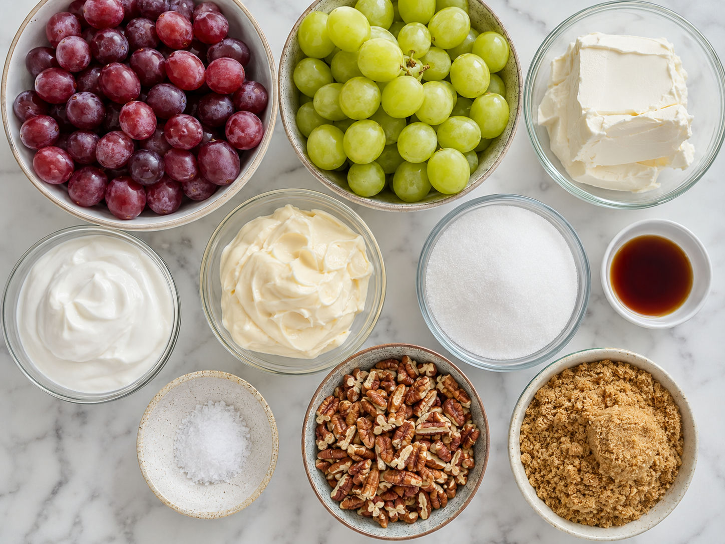 Ingredients for pecan grape salad with grapes, cream cheese, sour cream, and pecans