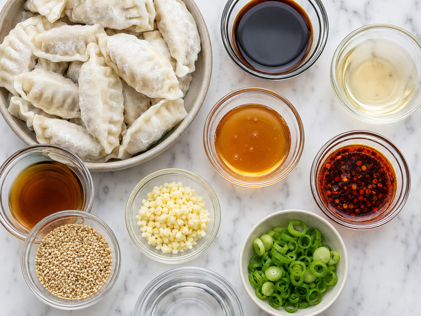 Ingredients for chili garlic dumplings with soy sauce, honey, garlic, and sesame