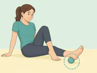 Person rolling the arch of the foot over a ball.