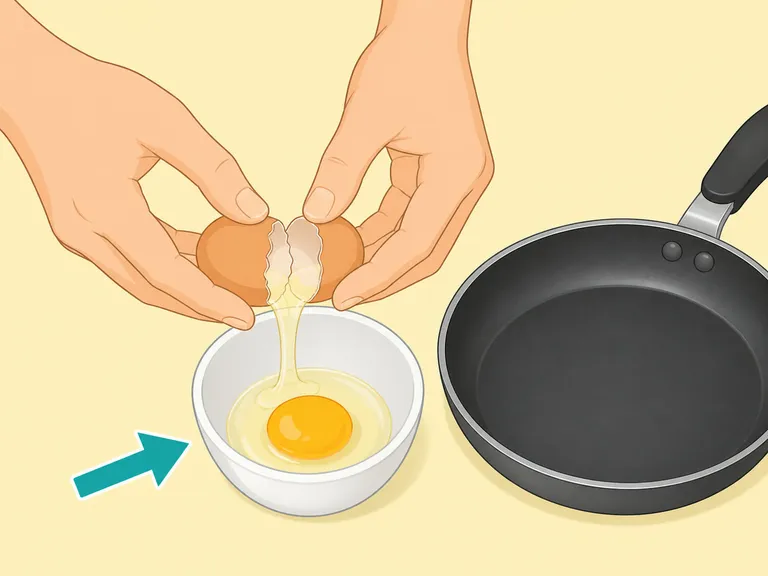 An egg cracked into a small bowl before being added to the pan.